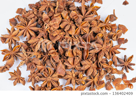 Dried brown star anise pods and seeds perfect for tea blends. Arrangement of dried star anise and seeds showcasing herbal and aromatic qualities suitable for culinary features Dried brown star anise pods and seeds perfect for tea blends. Arrangement of dried star anise and seeds showcasing herbal and aromatic qualities suitable for culinary features 136402409