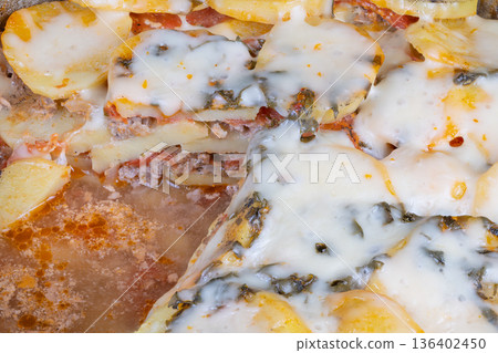 Artistic presentation of warm snack imagery. Vibrant social ready presentation of cheesy potato pizza. Detailed shot emphasizing glossy cheese melt and styled props on pizza Artistic presentation of warm snack imagery. Vibrant social ready presentation of cheesy potato pizza. Detailed shot emphasizing glossy cheese melt and styled props on pizza 136402450