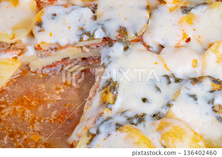 Potato cheese pie. Golden potato slices covered in gooey melted cheese on crispy crust. Thin crispy crust with layers of seasoned potatoes and rich melted cheese toppings 136402460
