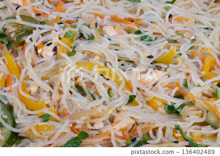 Colorful chicken and vegetable noodles. Quick and lively chicken mixed with peppers and noodles. Delicious and vibrant stirfried chicken with vegetables and flavorful noodles 136402489