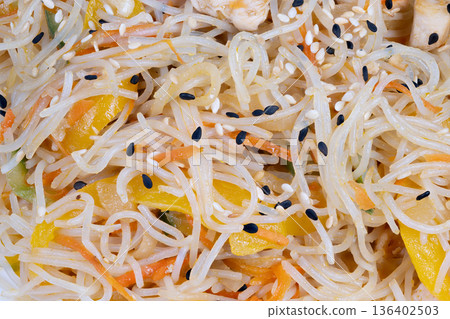 Juicy chicken with rice noodles. Fresh chicken paired with rice noodles and garden vegetables. Delicately cooked chicken combined with rice noodles and variety of garden greens 136402503