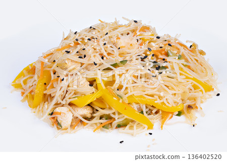 Hearty rice vermicelli tossed with yellow pepper and sesame, rustic street food energy and warm spice notes, handheld friendly portion on simple plate for casual dining Hearty rice vermicelli tossed with yellow pepper and sesame, rustic street food energy and warm spice notes, handheld friendly portion on simple plate for casual dining 136402520