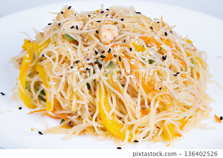 Crunchy rice nest. Delicious crispy noodle arrangement. Savory rice vermicelli with herbs. Freshly prepared crispy rice noodles with peppers and sesame seeds 136402526