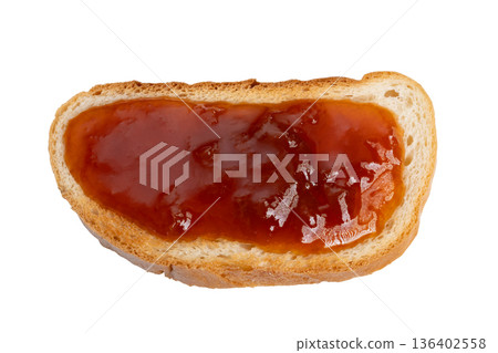 Comforting jam moment. Delicious homemade jam served on toasted bread with rustic charm. Cozy kitchen scene featuring sticky fruit jam spread on freshly toasted bread for comfort 136402558