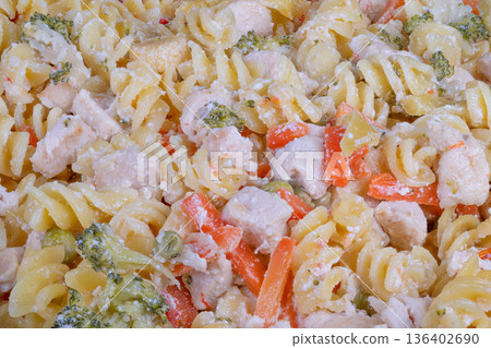 Vibrant healthy meal. Nutritious veggie chicken pasta. Colorful and nourishing pasta with vegetables. Wholesome chicken and vegetable pasta with vibrant colors and flavors 136402690