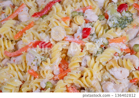 Hearty evening vegetable pasta dish. Silky fusilli with vegetables for warm family dinner. Velvety fusilli pasta with colorful vegetables served in cozy home setting Hearty evening vegetable pasta dish. Silky fusilli with vegetables for warm family dinner. Velvety fusilli pasta with colorful vegetables served in cozy home setting 136402812