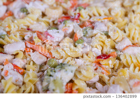 Nutritious veggie pasta. Wholesome vegetable pasta dish. Healthy mixed pasta with vibrant vegetables. Balanced chicken and vegetable fusilli for nutritious meal 136402899