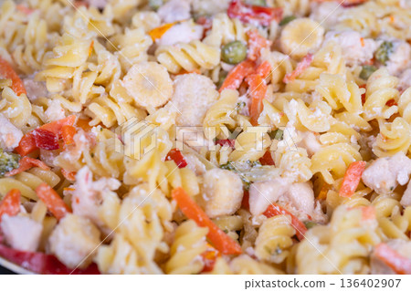 Vivid fusilli with vegetables served. Savor bright and flavorful chicken vegetable pasta. Relish colorful fusilli dish featuring chicken and fresh vegetables in every bite 136402907