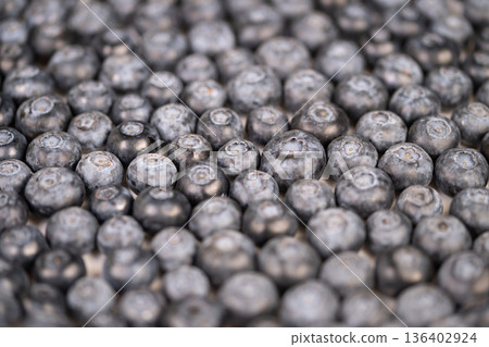 Earthtoned blueberries vividly illustrate environmentally conscious farming techniques. Rustic blueberries serve as visual symbols of sustainable practices in natural agriculture 136402924