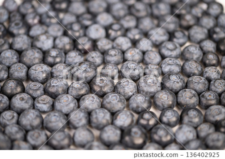 Dense blueberry pattern ideal for packaging, repetitive circular forms, neutral lighting and subtle skin bloom create seamless texture for label and web backgrounds 136402925