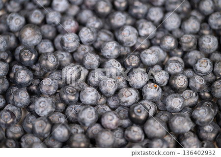 Highlighting fresh blueberries with natural textures and subtle hues. Showcasing detailed closeup of organic blueberries emphasizing natural bloom and market ambiance Highlighting fresh blueberries with natural textures and subtle hues. Showcasing detailed closeup of organic blueberries emphasizing natural bloom and market ambiance 136402932