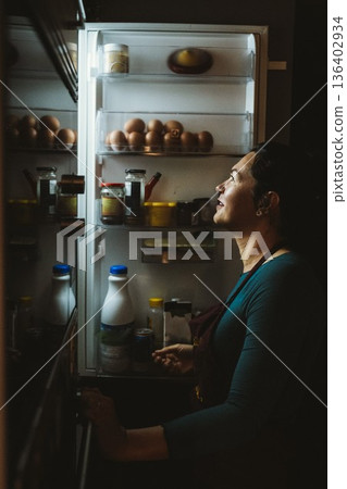 Woman Searching for Food in Refrigerator Woman Searching for Food in Refrigerator 136402934