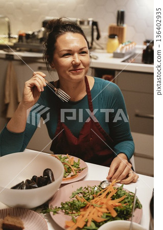 Woman Enjoying Healthy Meal at Home Kitchen Table Woman Enjoying Healthy Meal at Home Kitchen Table 136402935