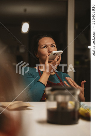 Woman Using Smartphone Voice Assistant at Home Woman Using Smartphone Voice Assistant at Home 136402936