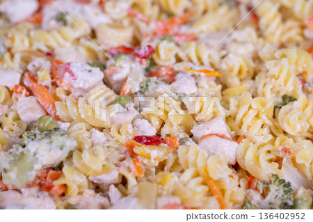 Nutritious meal with vegetables. Delicious fiberrich pasta with colorful peppers. Wholesome vegetable pasta combining peas and sweet peppers for health enthusiasts Nutritious meal with vegetables. Delicious fiberrich pasta with colorful peppers. Wholesome vegetable pasta combining peas and sweet peppers for health enthusiasts 136402952