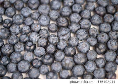 Scattered blueberries for breakfast recipe inspiration, soft natural light, slight shadowing, versatile ingredient mood for smoothie bowls, oatmeal, pastry and healthy menus Scattered blueberries for breakfast recipe inspiration, soft natural light, slight shadowing, versatile ingredient mood for smoothie bowls, oatmeal, pastry and healthy menus 136402954