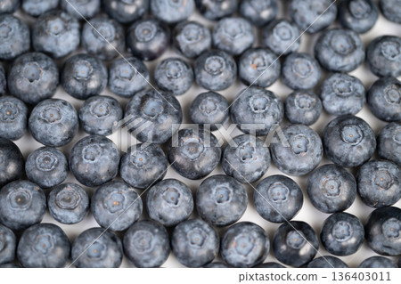 Vibrant scene featuring fresh blueberries in wholesome breakfast setting. An inviting display of succulent blueberries arranged for nutritious meal with sunlight ambiance 136403011