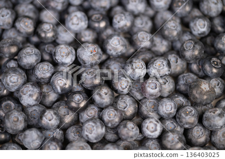 Minimalist blueberry cluster with soft lighting and balanced space. Stylish blueberry grouping set against plain background with gentle illumination and open negative space 136403025