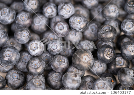 Varied blueberries displayed. Assorted blueberries with delicate bloom. Closeup of colorful blueberries for baking. Detailed shot of diverse blueberries with soft powder coating 136403177