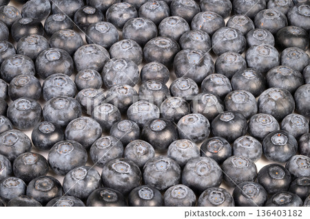 Close up blueberries used as food styling backdrop, moody light and subtle contrast create editorial mood for recipe or lifestyle shoot, emphasis on color and form 136403182