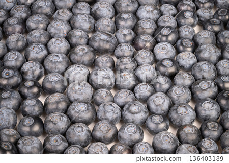 Blueberry display artfully. Fresh blueberry bunches arranged neatly in grid. Neatly organized clusters of ripe blueberries forming attractive geometric grid pattern Blueberry display artfully. Fresh blueberry bunches arranged neatly in grid. Neatly organized clusters of ripe blueberries forming attractive geometric grid pattern 136403189