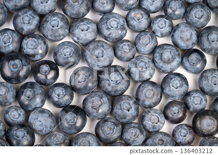 Ripe organic blueberry harvest closeup, matte powdery skin and varied sizes suggest fresh pick from farm, rustic mood suitable for farmers market and seasonal produce imagery Ripe organic blueberry harvest closeup, matte powdery skin and varied sizes suggest fresh pick from farm, rustic mood suitable for farmers market and seasonal produce imagery 136403212