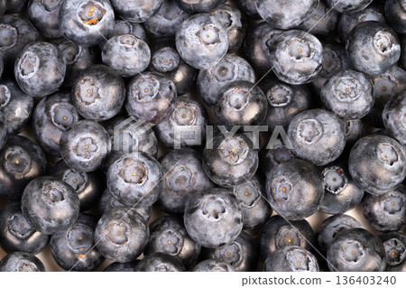 Closeup blueberries smoothie bowl recipe prep, frozen bloom shimmer, antioxidantrich appeal, vibrant indigo color, breakfast inspiration, spoon and granola pairing suggested Closeup blueberries smoothie bowl recipe prep, frozen bloom shimmer, antioxidantrich appeal, vibrant indigo color, breakfast inspiration, spoon and granola pairing suggested 136403240