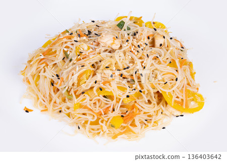 Nutritious rice vermicelli enhanced with colorful vegetables and sesame. Balanced lowfat rice noodles garnished with yellow peppers and sesame seeds for texture 136403642