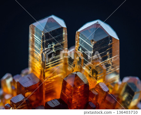 Unique crystal formation with sharp peaks and varied colors on a dark background during daylight 136403710