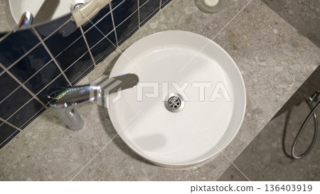 Modern bathroom sink design featuring sleek lines and stylish finishes in a serene, minimalist setting Modern bathroom sink design featuring sleek lines and stylish finishes in a serene, minimalist setting 136403919