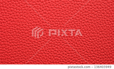 Vibrant texture of red leather, showcasing rich color and intricate pattern under bright light 136403949
