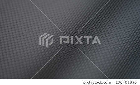 Textured surface displaying intricate geometric patterns in rich dark tones, creating a sense of modern elegance and depth in design 136403956