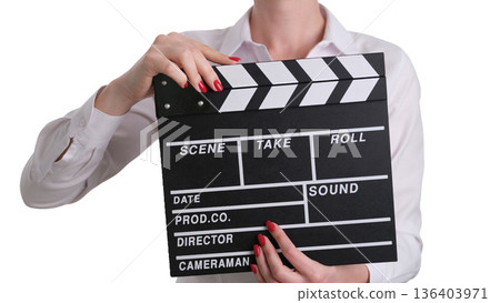 Creative movie planning session with a clapperboard held by a director in a bright studio setting during the daytime Creative movie planning session with a clapperboard held by a director in a bright studio setting during the daytime 136403971