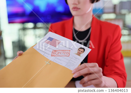 Job seeker receives disappointing news in an office setting during daylight hours 136404013