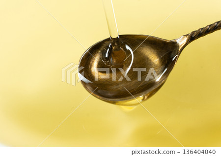 Refined Sunflower Oil Pouring into Spoon, Frozen Motion Macro Refined Sunflower Oil Pouring into Spoon, Frozen Motion Macro 136404040