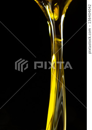 Vertical Abstract Background Flow Of Unrefined Oil On Black Background, Space For Text, Macro Texture 136404042