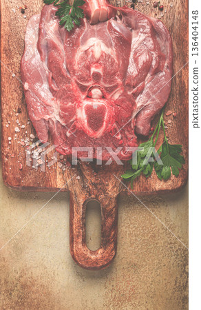 raw steak, veal neck on the bone, fresh meat, on a cutting board, with spices, top view, without people, 136404148