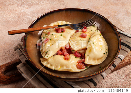 Dumplings, with fried prosciutto, a traditional dish of Polish cuisine, dumplings, top view, close-up, without people, 136404149