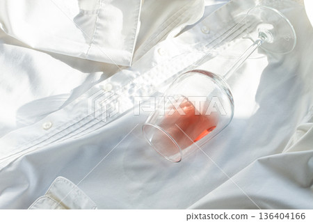 Glass, with pink wine, spilled on a white shirt, close-up, selective focus, no people, concept, top view, 136404166