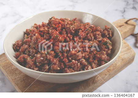raw minced meat, marinated with spices and herbs, in a bowl, minced meat with spices, top view, homemade, no people, raw minced meat, marinated with spices and herbs, in a bowl, minced meat with spices, top view, homemade, no people, 136404167