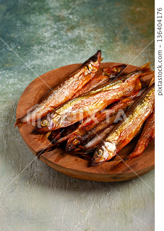 cold smoked capelin, on a wooden bowl, top view, no people, 136404176