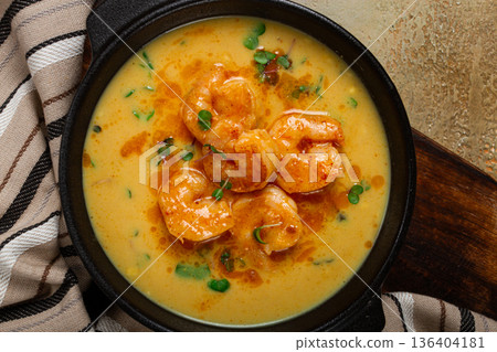 Creamy shrimp curry with spices, garnished with herbs, on a textured background, homemade , no people, Creamy shrimp curry with spices, garnished with herbs, on a textured background, homemade , no people, 136404181