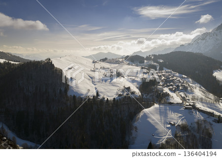 Nice shot of snow-covered mountain village at sunny day Nice shot of snow-covered mountain village at sunny day 136404194