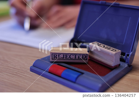 Stamped with finality, the rejection letter marks the end of another application journey in the quiet office space Stamped with finality, the rejection letter marks the end of another application journey in the quiet office space 136404257