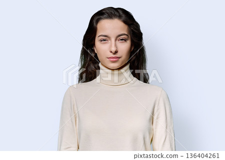 Portrait of beautiful smiling teenage woman against white studio background Portrait of beautiful smiling teenage woman against white studio background 136404261