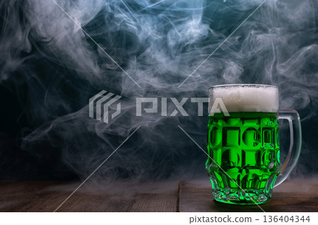 Green beer, hat and clover leaves on grey wooden table. St. Patrick Day celebration Green beer, hat and clover leaves on grey wooden table. St. Patrick Day celebration 136404344