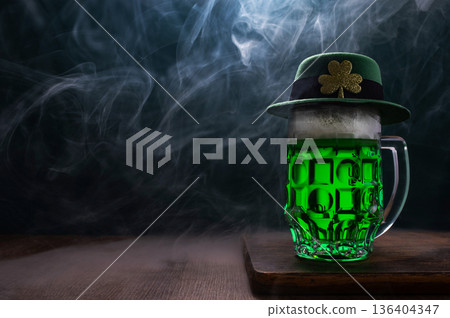 Green beer, hat and clover leaves on grey wooden table. St. Patrick Day celebration 136404347