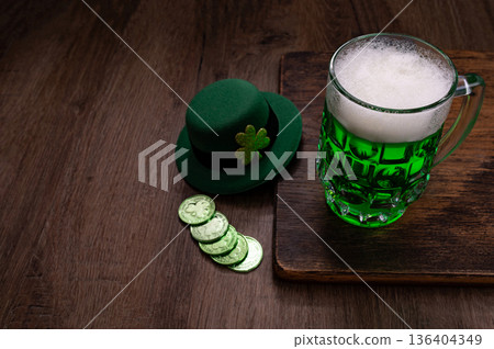 Green beer, hat and clover leaves on grey wooden table. St. Patrick Day celebration Green beer, hat and clover leaves on grey wooden table. St. Patrick Day celebration 136404349