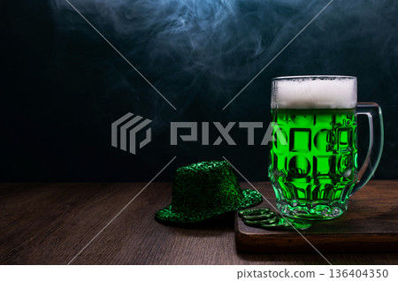 Green beer, hat and clover leaves on grey wooden table. St. Patrick Day celebration Green beer, hat and clover leaves on grey wooden table. St. Patrick Day celebration 136404350
