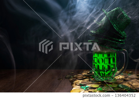 Green beer, hat and clover leaves on grey wooden table. St. Patrick Day celebration Green beer, hat and clover leaves on grey wooden table. St. Patrick Day celebration 136404352